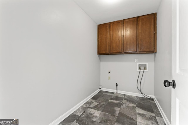 laundry area with washer hookup, hookup for an electric dryer, stone finish flooring, cabinet space, and baseboards