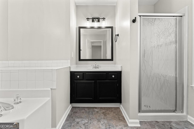 full bathroom featuring vanity, baseboards, and a stall shower