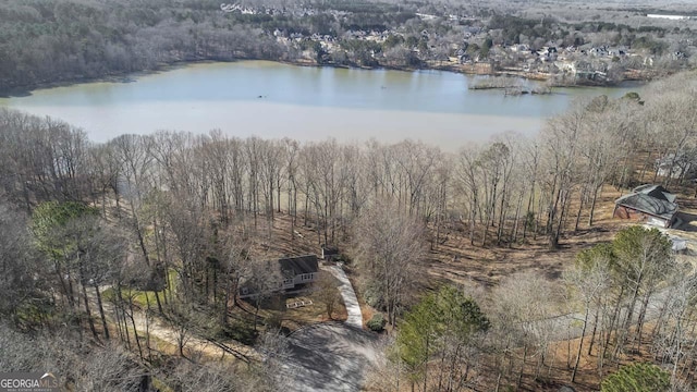 drone / aerial view with a view of trees and a water view