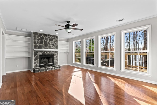 unfurnished living room featuring built in features, a ceiling fan, hardwood / wood-style flooring, and visible vents