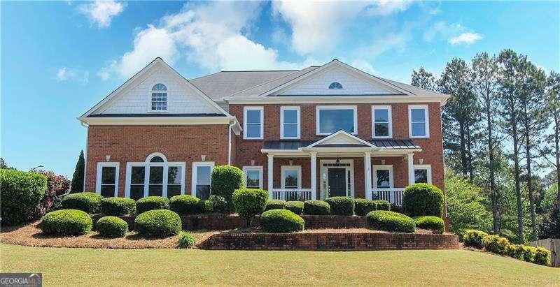 5029 Preservation Pointe Pointe, Kennesaw, GA 30152 - view of front of home featuring covered porch, brick siding, and a front lawn