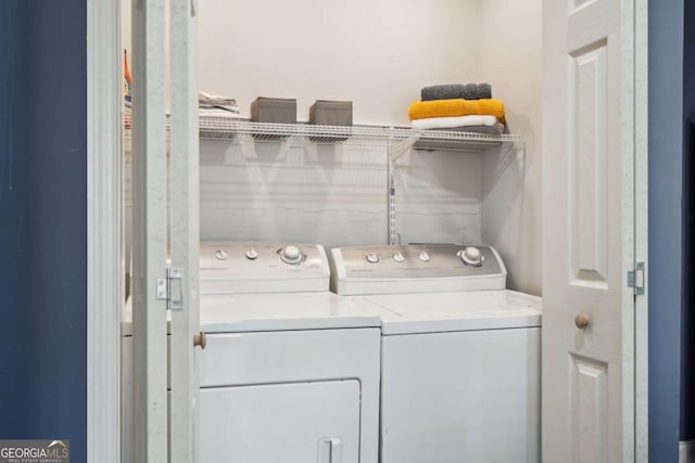 clothes washing area featuring laundry area and washer and dryer