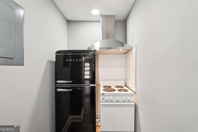 kitchen with wall chimney range hood, electric range, freestanding refrigerator, and electric panel