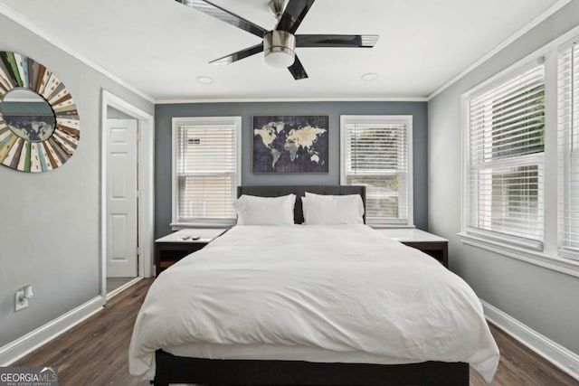 bedroom featuring crown molding, baseboards, and wood finished floors