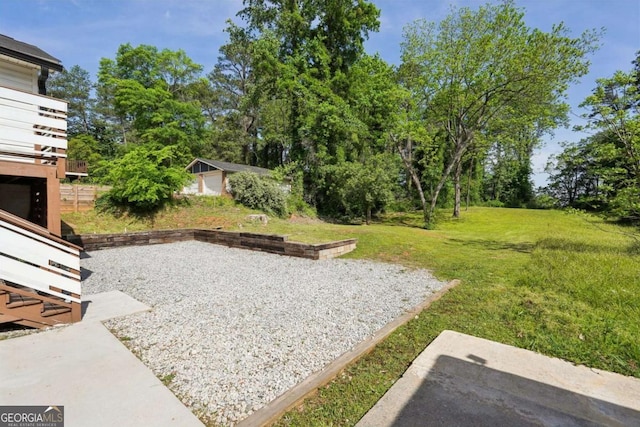 view of yard featuring an outbuilding and a patio area