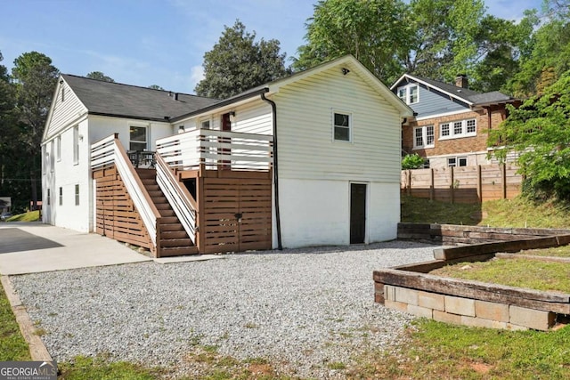 back of house with fence, stairway, and a deck