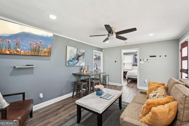 living area with a ceiling fan, baseboards, recessed lighting, and wood finished floors