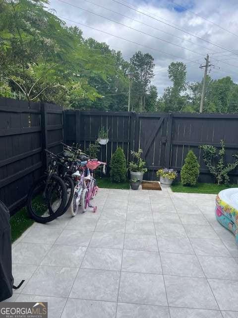 view of patio with a fenced backyard and a gate