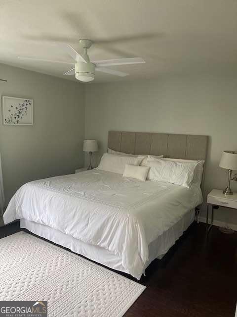 bedroom with a ceiling fan and wood finished floors