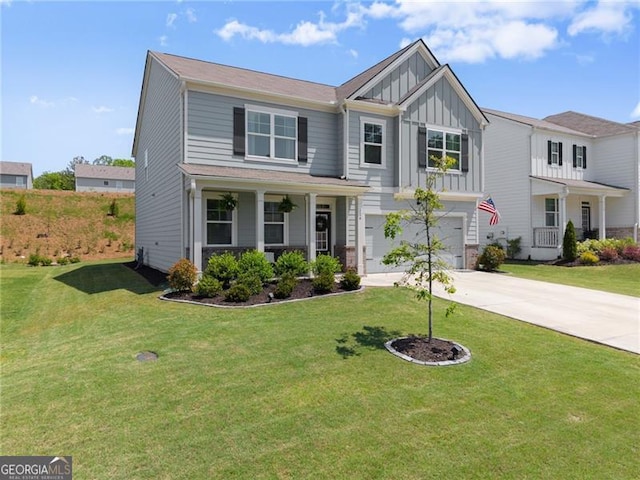 craftsman-style house with board and batten siding, an attached garage, concrete driveway, and a front yard