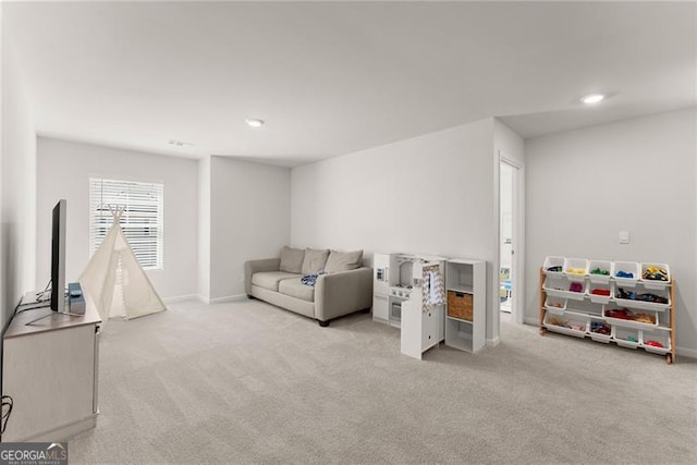 carpeted living room with recessed lighting and baseboards