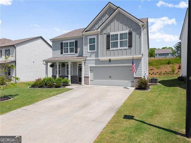 craftsman-style home with board and batten siding, a porch, driveway, a front lawn, and an attached garage