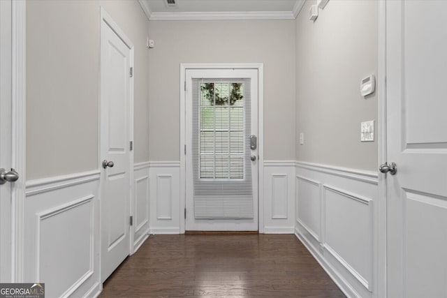doorway featuring a wainscoted wall, ornamental molding, a decorative wall, and dark wood-style floors