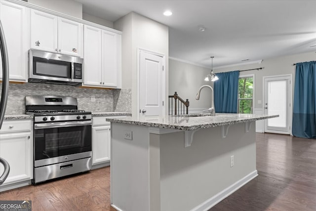 kitchen featuring dark wood-type flooring, appliances with stainless steel finishes, and white cabinets