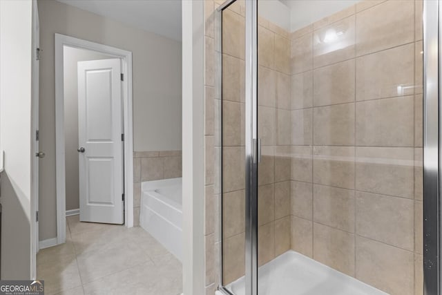 full bath featuring tile patterned floors, a shower stall, and a garden tub