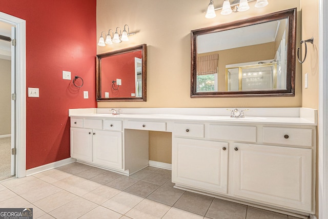 full bathroom featuring double vanity, a sink, a stall shower, and tile patterned floors