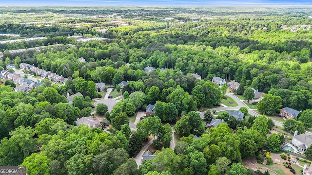 birds eye view of property featuring a residential view and a wooded view