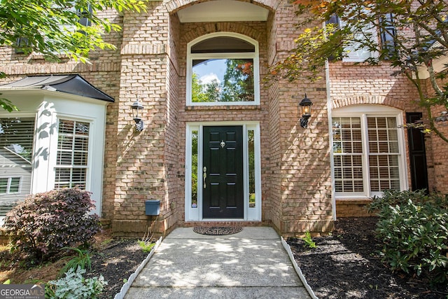 entrance to property with brick siding