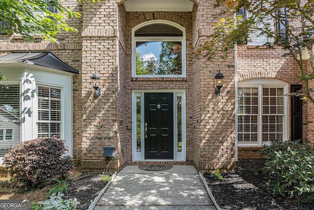 property entrance with brick siding