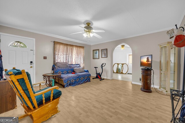 415 Scenic Dr, Toccoa, GA 30577 - living room featuring a ceiling fan, plenty of natural light, arched walkways, light wood-type flooring, and ornamental molding
