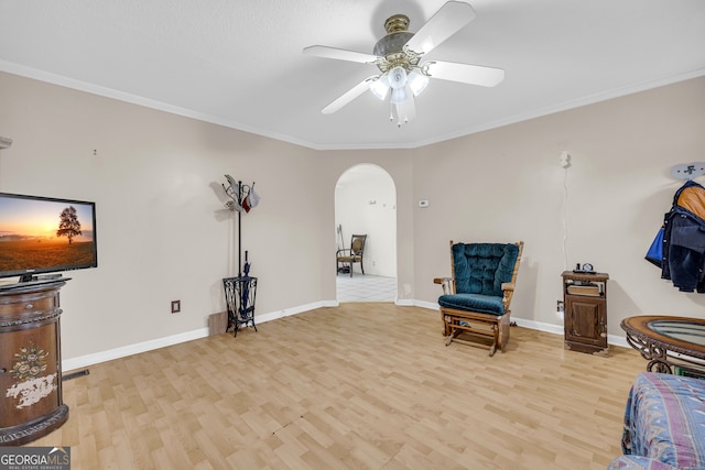 415 Scenic Dr, Toccoa, GA 30577 - sitting room featuring crown molding, a ceiling fan, light wood-style floors, baseboards, and arched walkways
