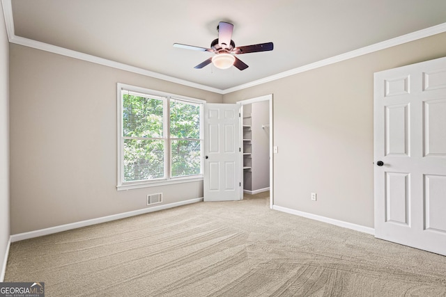 760 Swan Ln, Canton, GA 30115 - unfurnished bedroom with carpet floors, ornamental molding, ceiling fan, and a walk in closet
