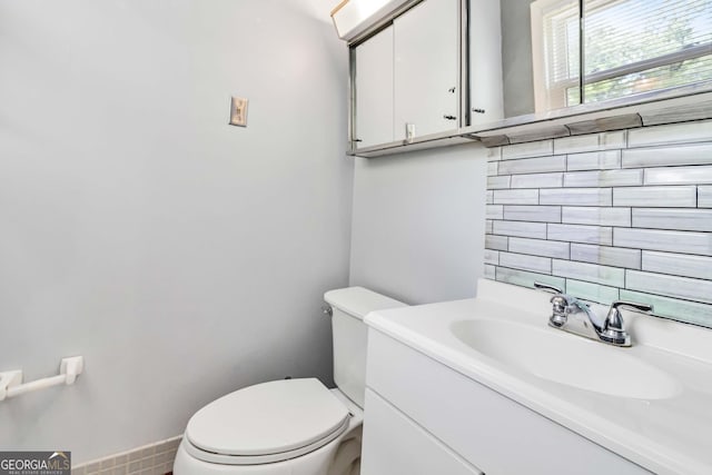 half bathroom with vanity and toilet