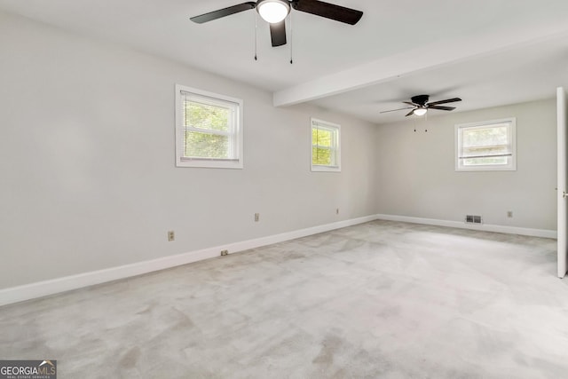 spare room with baseboards, a ceiling fan, light colored carpet, and visible vents