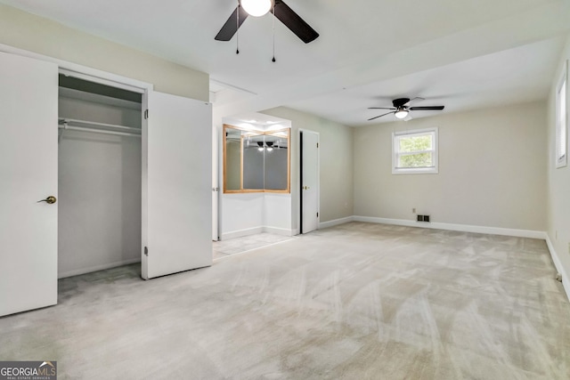 unfurnished bedroom with baseboards, ceiling fan, a closet, and carpet floors