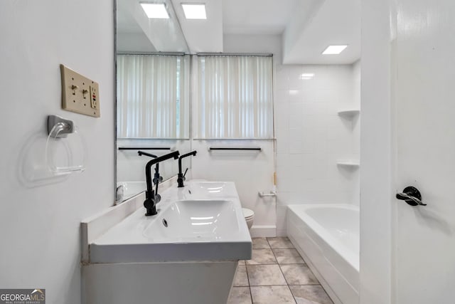 bathroom with double vanity and toilet