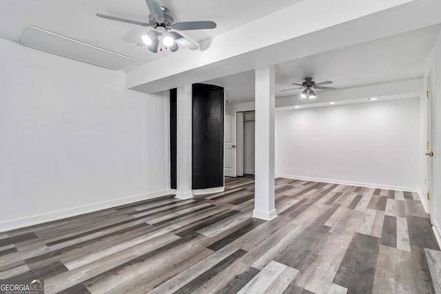 basement with baseboards, ceiling fan, and wood finished floors