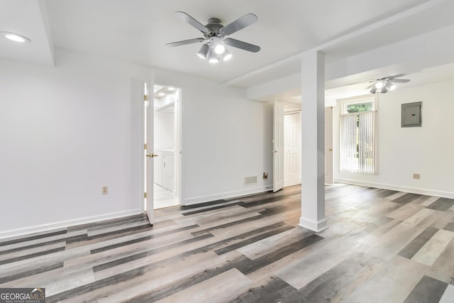 unfurnished living room featuring ceiling fan, electric panel, and wood finished floors