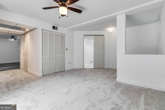 unfurnished bedroom with carpet floors, baseboards, and visible vents