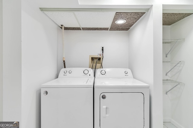 washroom with separate washer and dryer and laundry area