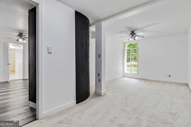 unfurnished living room featuring a ceiling fan and baseboards