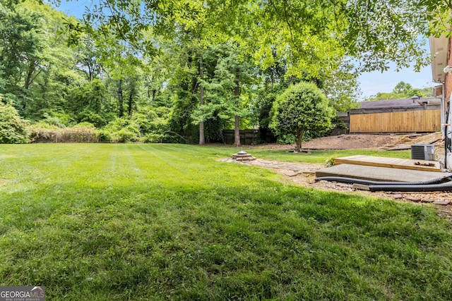 view of yard with fence and cooling unit