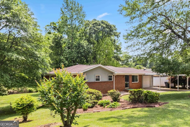 view of front of property with stucco siding, brick siding, a front lawn, and a garage