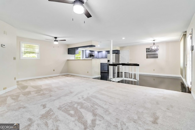 unfurnished living room with baseboards, carpet flooring, ceiling fan, and recessed lighting