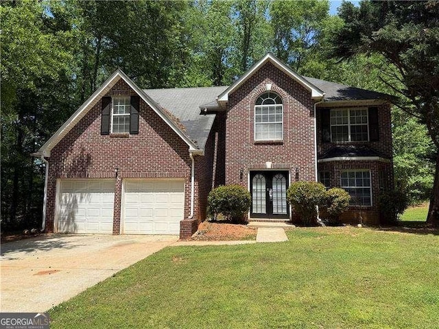 99 Ashtonbrook Dr, Mcdonough, GA 30252 - view of front of house with a front yard, french doors, brick siding, an attached garage, and driveway