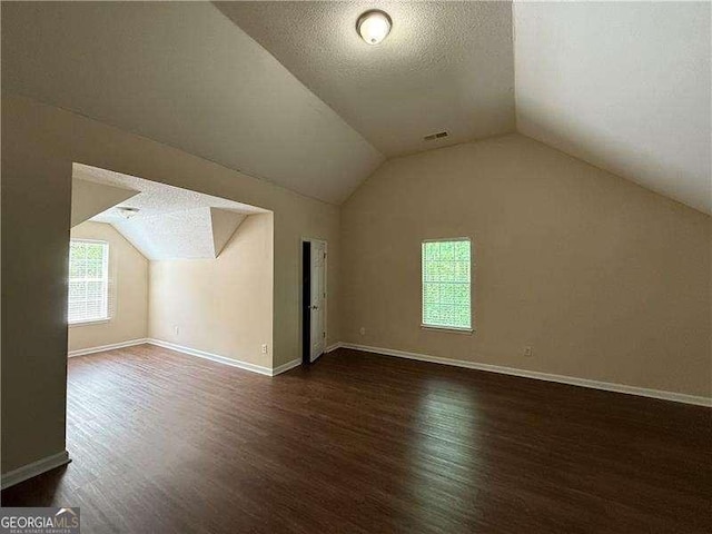 99 Ashtonbrook Dr, Mcdonough, GA 30252 - additional living space with a textured ceiling, baseboards, wood finished floors, lofted ceiling, and visible vents