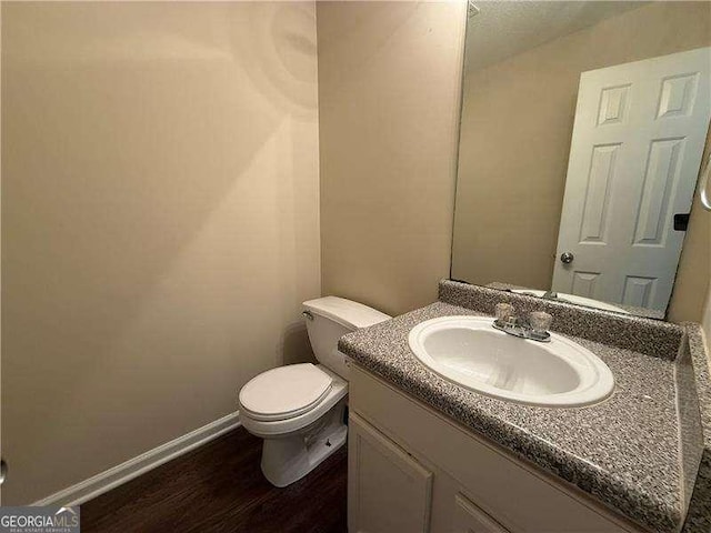 99 Ashtonbrook Dr, Mcdonough, GA 30252 - bathroom with toilet, baseboards, wood finished floors, and vanity