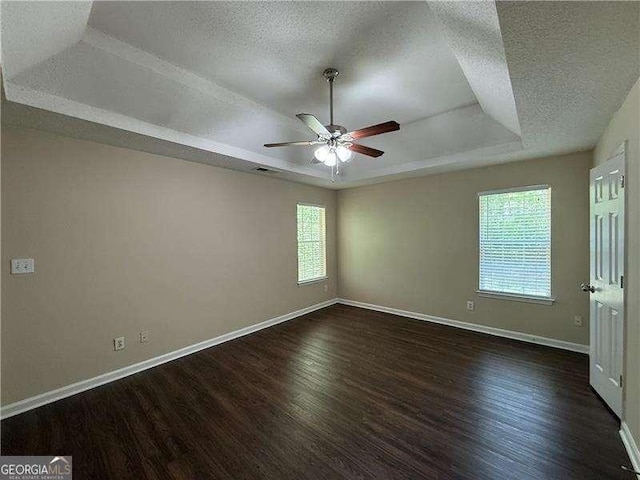 99 Ashtonbrook Dr, Mcdonough, GA 30252 - unfurnished bedroom with visible vents, wood finished floors, baseboards, a textured ceiling, and a tray ceiling