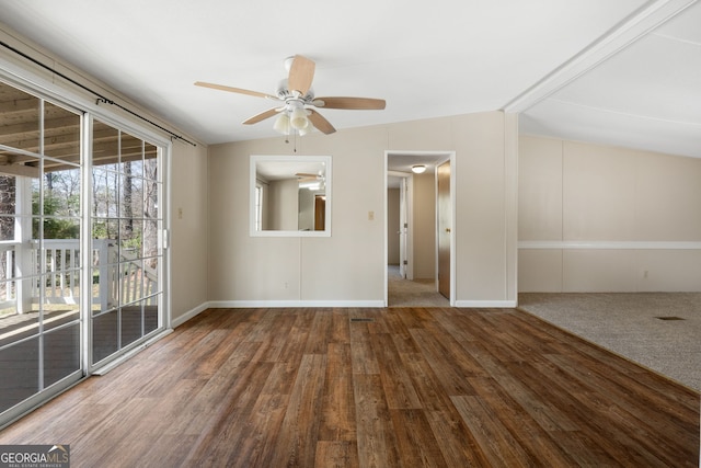 spare room featuring baseboards, ceiling fan, wood finished floors, and lofted ceiling