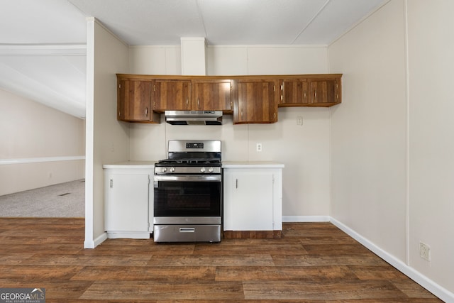 kitchen featuring light countertops, dark wood finished floors, brown cabinetry, stainless steel range with gas cooktop, and under cabinet range hood