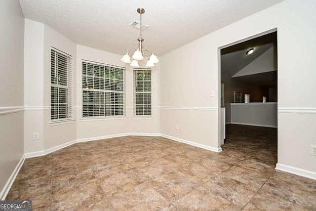 unfurnished dining area with visible vents, a textured ceiling, and a chandelier