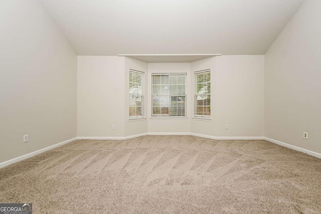unfurnished room with baseboards and carpet flooring