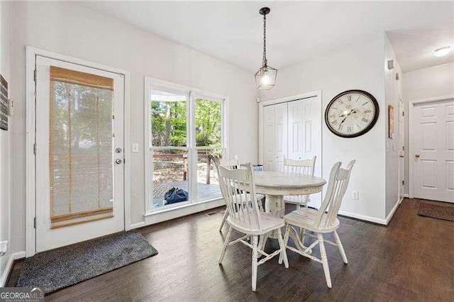 dining space with baseboards and dark wood-style floors