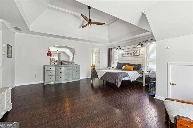 bedroom featuring baseboards, a ceiling fan, wood finished floors, and visible vents