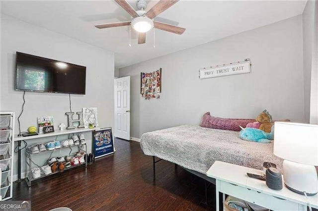bedroom featuring baseboards, ceiling fan, and wood finished floors