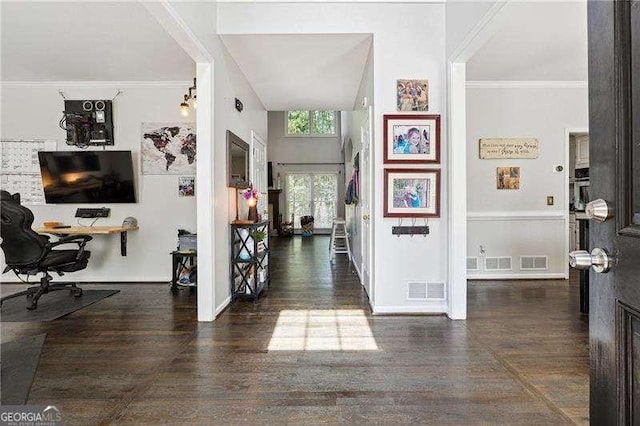 entryway featuring baseboards, visible vents, and wood finished floors